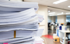 Stacks of documents in an office. Higher Education Data Problems FormAssembly Blog Header
